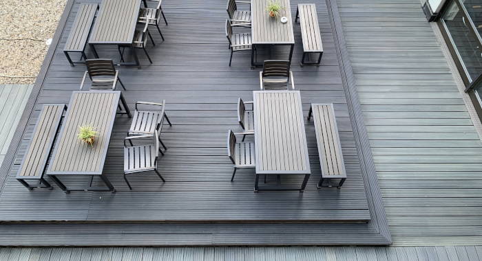 Eine Terrasse und Gartenmöbel aus Holz.